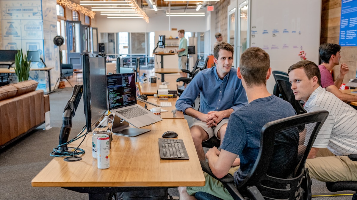 Marketing strategists reviewing campaign performance on a large screen in a modern office