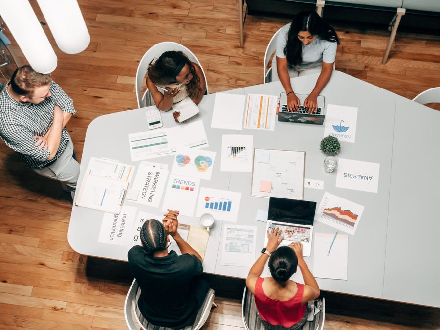 Paid media specialists reviewing ad performance metrics